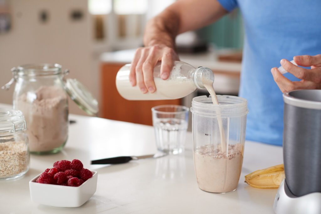 close-up-of-man-making-protein-shake-after-exercis-2021-08-26-16-14-47-utc-1024x683.jpg