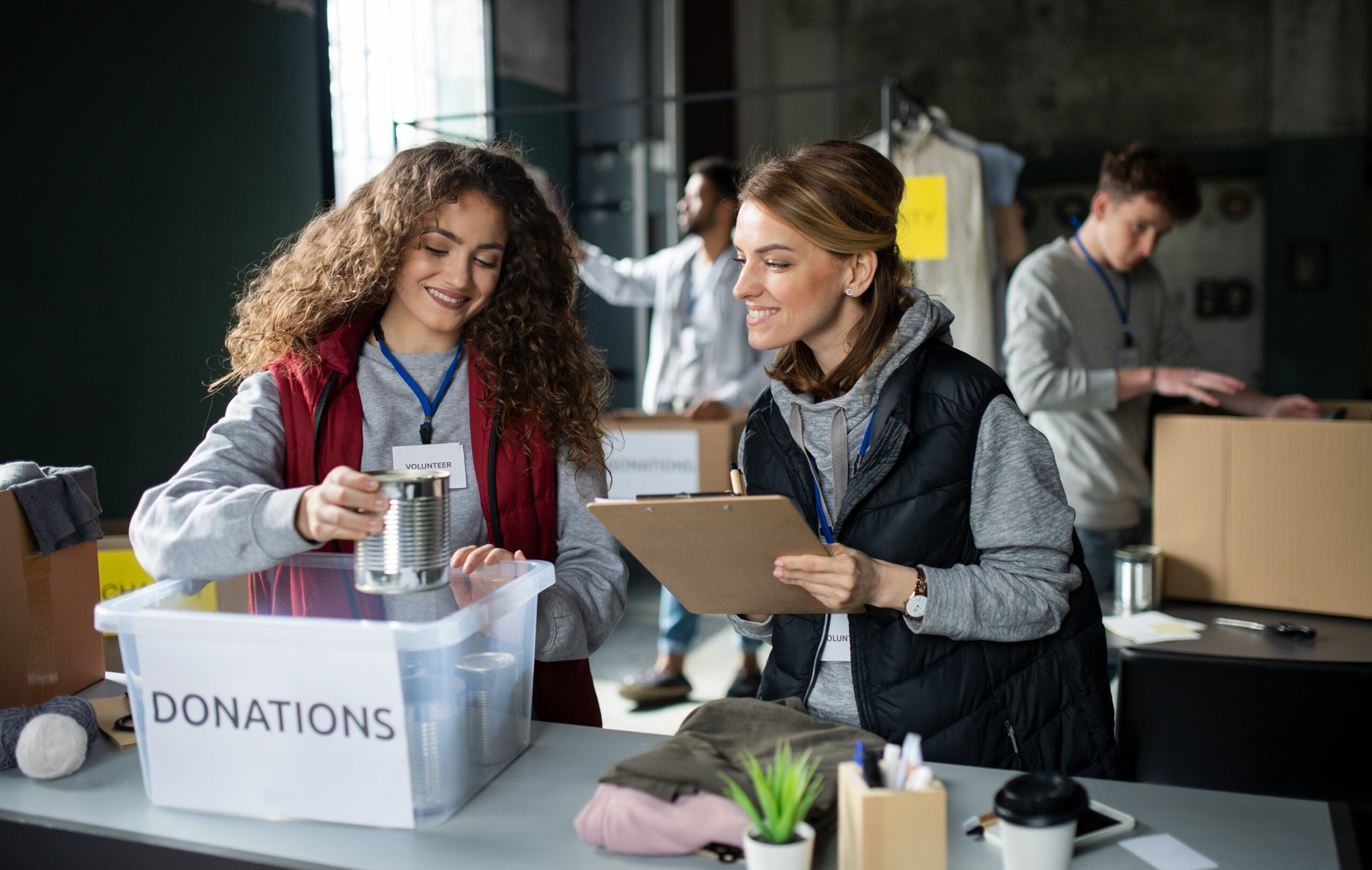 Group of volunteers working in community charity donation center ...